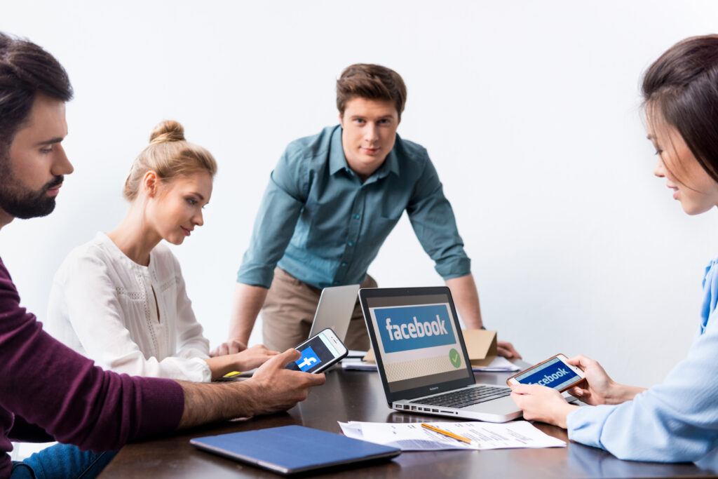 young businesspeople using digital devices with fa 6AAEZNM scaled